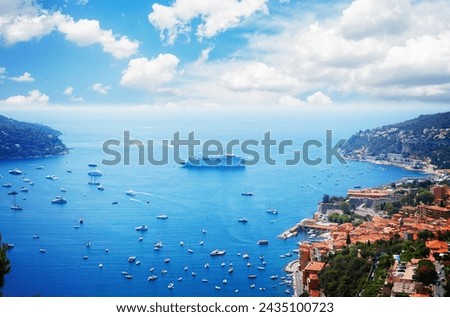 colorful coast and turquiose water with boats and ships, cote dAzur, France, retro toned Royalty-Free Stock Photo #2435100723