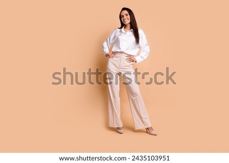 Full length photo of gorgeous cheerful person put hands waist posing empty space ad isolated on beige color background