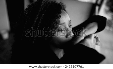 Contemplative South American Latina in 50s, Deep Rumination on Balcony in Monochrome, middle-aged female person struggling with depression gazing at distance from residence Royalty-Free Stock Photo #2435107761