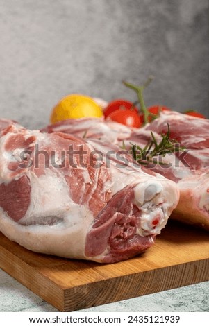 leg of lamb. Butcher products. Raw lamb leg meat with bones on stone background