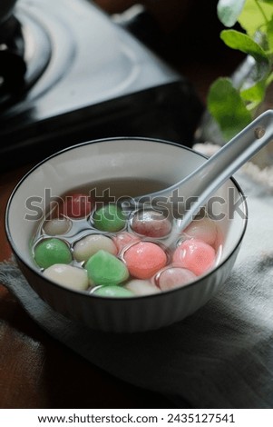 Tang Yuan is a Chinese dessert made of glutinous rice flour balls served in sweet soup. It's enjoyed during festivals like the Winter Solstice. Selective focus Royalty-Free Stock Photo #2435127541