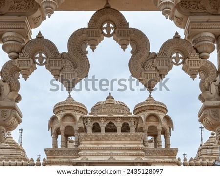 Entrance archway of The Shree Sanatan Hindu Mandir Hindu Temple (The Shri Sanatan Hindu Temple). Gates of Neasden Temple build from Elaborately carved Jaisalmer limestone,  Royalty-Free Stock Photo #2435128097