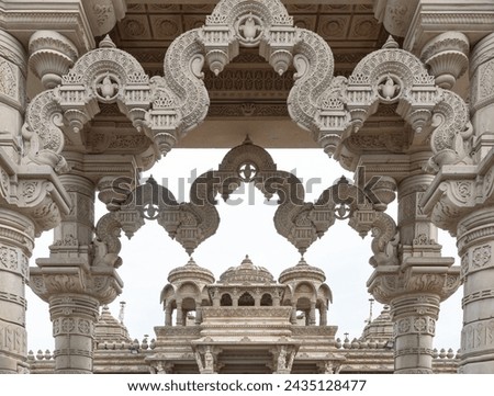 Entrance archway of The Shree Sanatan Hindu Mandir Hindu Temple (The Shri Sanatan Hindu Temple). Gates of Neasden Temple build from Elaborately carved Jaisalmer limestone,  Royalty-Free Stock Photo #2435128477