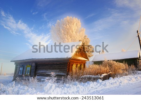 Winter landscape with frozen tree and wooden house at sunrise, Russia