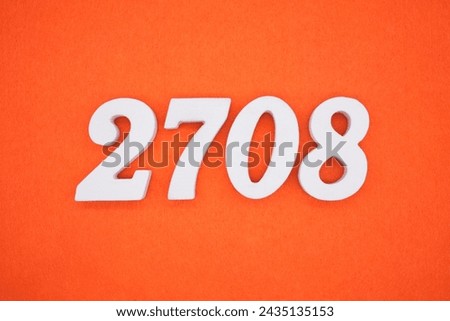Orange felt is the background. The numbers 2708 are made from white painted wood. Royalty-Free Stock Photo #2435135153