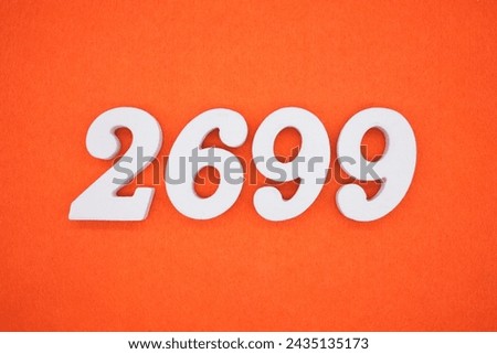 Orange felt is the background. The numbers 2699 are made from white painted wood.