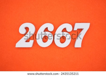 Orange felt is the background. The numbers 2667 are made from white painted wood.