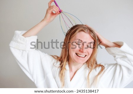 Girl use Manual Head Massager of Steel wire . High quality photo