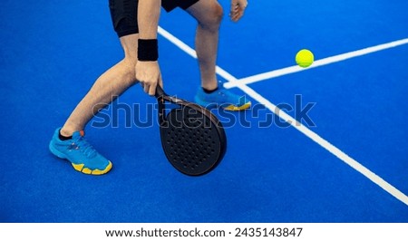 Close-up padel photo. Open Tour template. Padel tennis player on the blue court background outdoors. Paddle tenis template for bookmaker design ads with copy space. Mockup for betting advertisement.