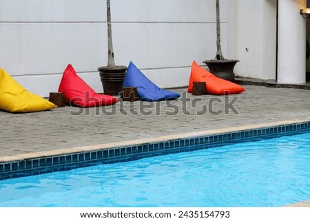 Swimming pool of a hotel with clear water and fountain. Perfect for photo illustration, background, or architectural purposes. 