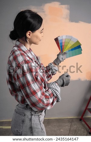 painter woman with color swatches in your hands, rear view. Copy space
