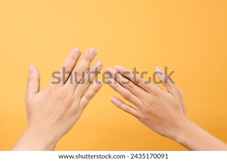 Asian muslim greeting hand gesture between man and woman during Eid mubarak celebration, hand finger tip touching Royalty-Free Stock Photo #2435170091