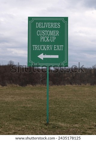 TRIADELPHIA, WV, USA - FEBRUARY 27, 2024:  Signage behind a local shiopping center directs trucks and customers to delivery and pick-up locations.