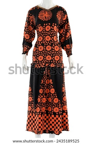 Women's suit with long sleeves, long skirt, have a feminine pattern made from soft and cool satin. Royalty-Free Stock Photo #2435189525