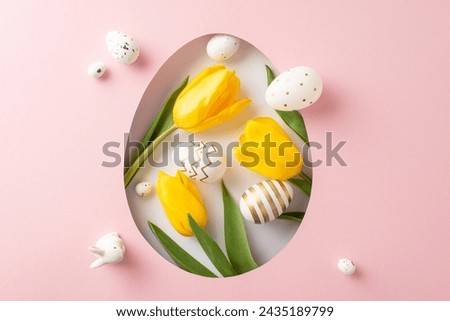 Happy Easter theme: top view perspective of blooming yellow tulips, a rabbit silhouette, and decorated eggs shown through an egg-shaped hole on a pastel pink canvas, with space for festive messages Royalty-Free Stock Photo #2435189799