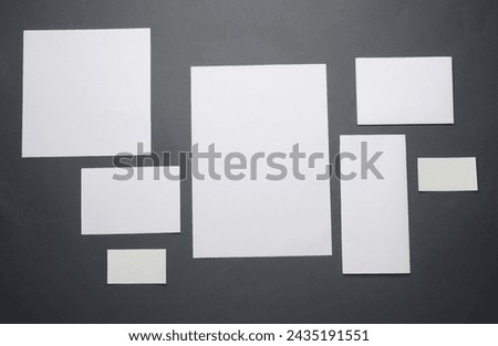 Mockup for design of white blank sheets of paper of different sizes and shapes, cards on dark gray background. Corporate identification. Creative layout