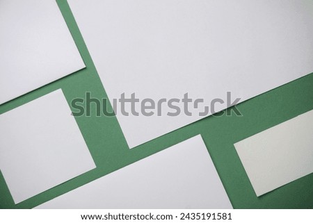 Mockup for design of white blank sheets of paper of different sizes and shapes, cards, envelope on green background. Corporate identification. Creative layout