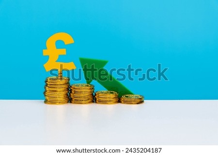 Green arrow on pile pound coins