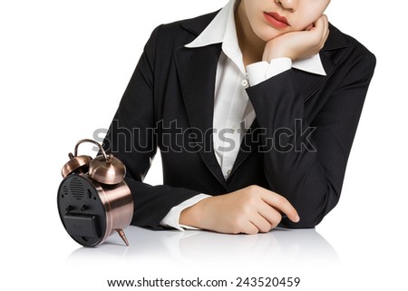 Business woman looking the alarm clock in boredom isolated on white background.