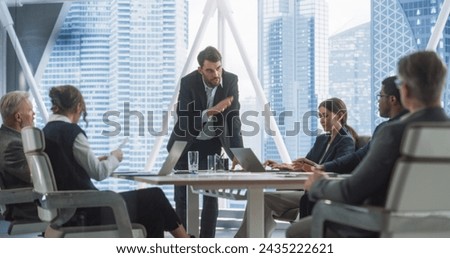 Office Conference Room Meeting Presentation: Caucasian Businessman Talks, Uses Green Screen Chroma Key TV Set. Male CEO Successfully Presenting a e-Commerce Product to Group of Multi-Ethnic Investors.