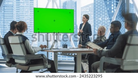 Office Conference Room Presentation: Beautiful Businesswoman Talks, Uses Green Screen Chroma Key TV Set. Digital Entrepreneur Presents e-Commerce Product On Meeting With Group Diverse Investors.