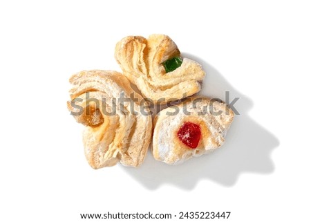 Indulge in a trio of delightful treats! Flaky puff pastry envelopes vibrant red Turkish Delight, dusted with a delicate veil of powdered sugar. Perfect for sharing or savoring one at a time. Royalty-Free Stock Photo #2435223447