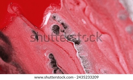 Abstract background. Liquid pigment. Colorful flow. Red brown pink white ink glitter particles smooth texture stream on surface macro trendy design.