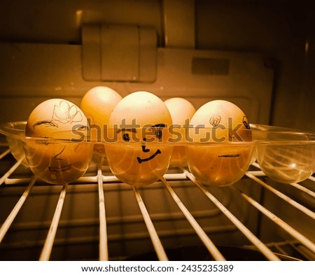 Easter bunny eggs inside the fridge. Taken closeup. Selective focus. Trending stock photo. Fun eggs. Painted faces.