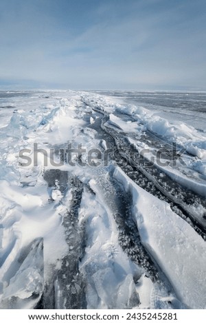 Ice of lake Baikal in winter, the deepest and largest freshwater lake by volume in the world, located in southern Siberia, Russia Royalty-Free Stock Photo #2435245281