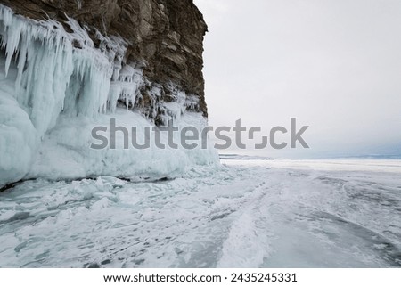 Coast of lake Baikal in winter, the deepest and largest freshwater lake by volume in the world, located in southern Siberia, Russia Royalty-Free Stock Photo #2435245331