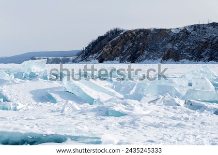 Coast of lake Baikal in winter, the deepest and largest freshwater lake by volume in the world, located in southern Siberia, Russia Royalty-Free Stock Photo #2435245333