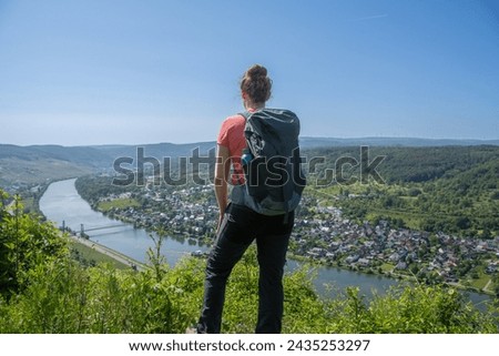 A hiker enjoys the view of the Moselle near Bernkastel-Kues Royalty-Free Stock Photo #2435253297