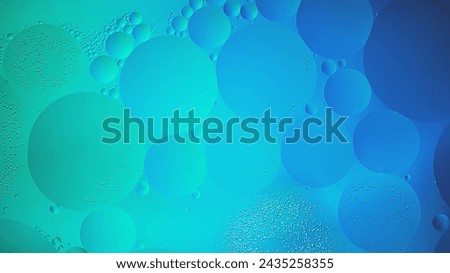 Abstract blue and green colorful background with oil on water surface. Oil drops in water abstract psychedelic, abstract image.