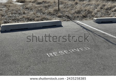 Parking space with a reserved sign painted on the asphalt 