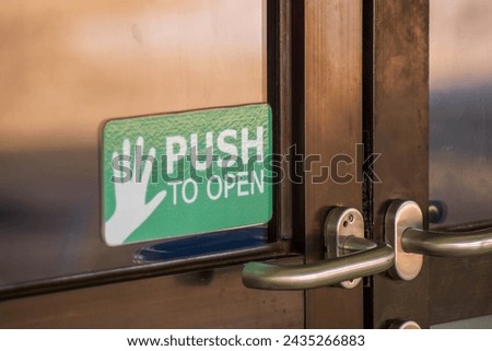 Close-up of the door with sign "push to open" on it