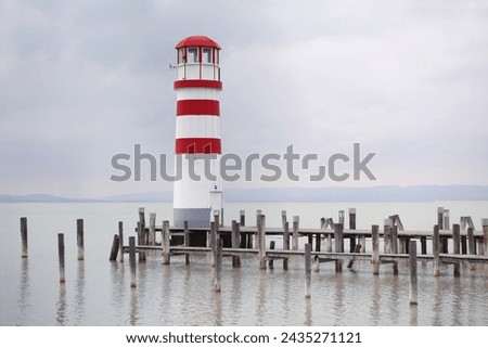 Lighthouse on lake neusiedler see,  early spring, cloudy weather, pastel tones serenity Royalty-Free Stock Photo #2435271121