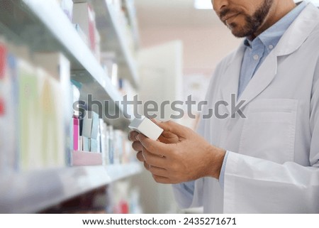Professional pharmacist with medicine in drugstore, closeup
