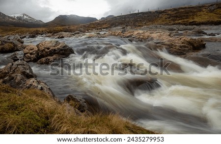 Fast flowing river over rocks in the remote highlands of Scotland