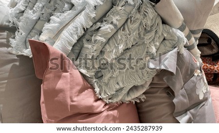 textile pillowcases and towels. fallen stacks of fringed towels, piles of bed linen
