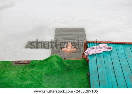 A man at traditional Epiphany bathing. Background with selective focus and copy space for text