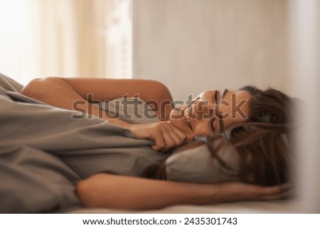 Relax, happy and woman in bed at her home on weekend morning for calm, rest or sleeping. Confident, smile and young female person laying with duvet blanket in bedroom at apartment in Canada. Royalty-Free Stock Photo #2435301743