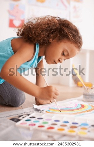 School, learning or girl painting a rainbow on classroom floor for creative, education or child development. Paper, color splash or cute kid with kindergarten art paint, sketch or having fun drawing