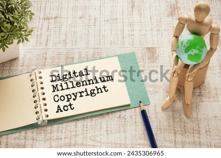 There is notebook with the word Digital Millennium Copyright Act. It is as an eye-catching image.