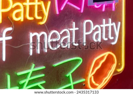 Neon food sign at night market stall