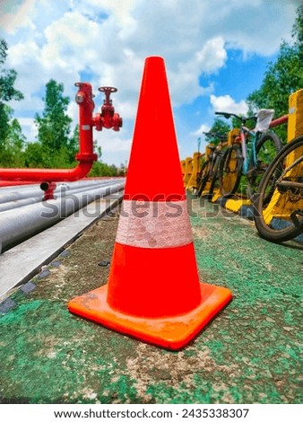 Traffic Cone or what is usually referred to as a traffic cone with an orange color and white edges