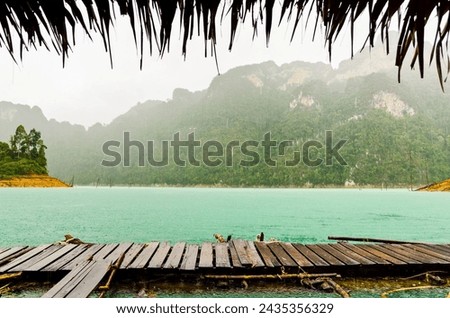 Mountain and river front of the hut while it was raining in Ratchaprapha Dam at Khao Sok National Park, Surat Thani Province, Thailand
 Royalty-Free Stock Photo #2435356329