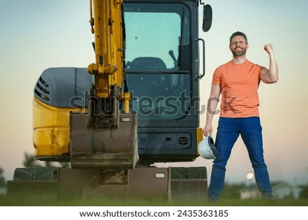Construction excited man industry with excavator at industrial site. Worker in helmet build with bulldozer. Engineer work with builder contractor in hardhat. Excavation foreman with tractor. Royalty-Free Stock Photo #2435363185