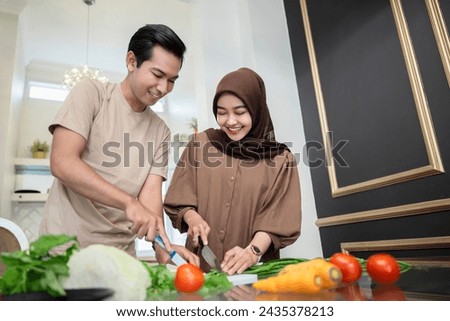 Portrait of a Muslim couple preparing food together in the kitchen
