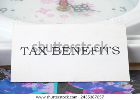 The concept of finance and business. TAX BENEFITS written on a white business card