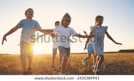 children running in park silhouette. people in park. children a kid together run in park at sunset silhouette. group of children run. happy lifestyle family and little baby child summer